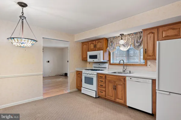 a kitchen with stainless steel appliances a stove a refrigerator and a sink
