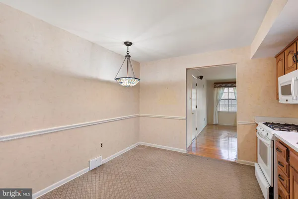 a view of a kitchen with a sink and dishwasher a stove top oven
