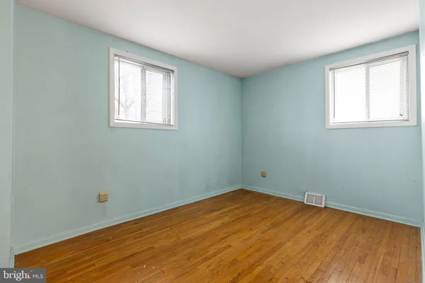 a view of a room with wooden floor and fan