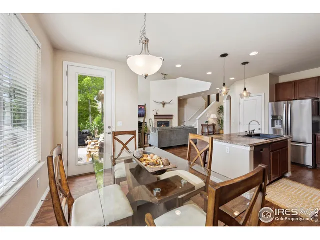 a living room with stainless steel appliances kitchen island granite countertop furniture and a large window