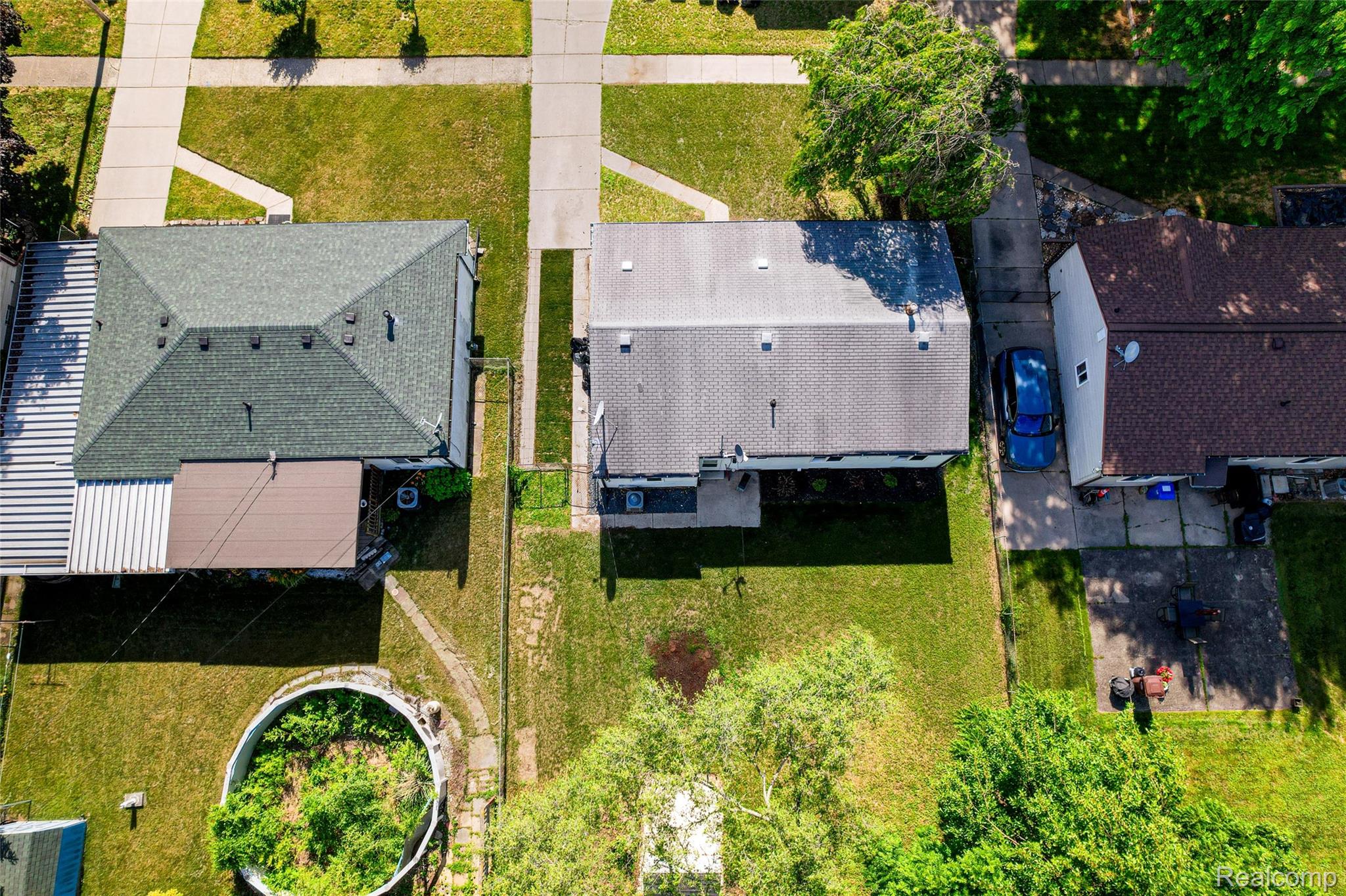 201 Cardwell Street Inkster, MI 48141 - Photo 41 of 41 Property with a large green roof, an attached brown metal awning, and a side-yard concrete driveway