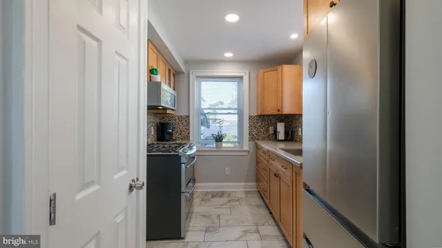 a kitchen with a refrigerator and a stove