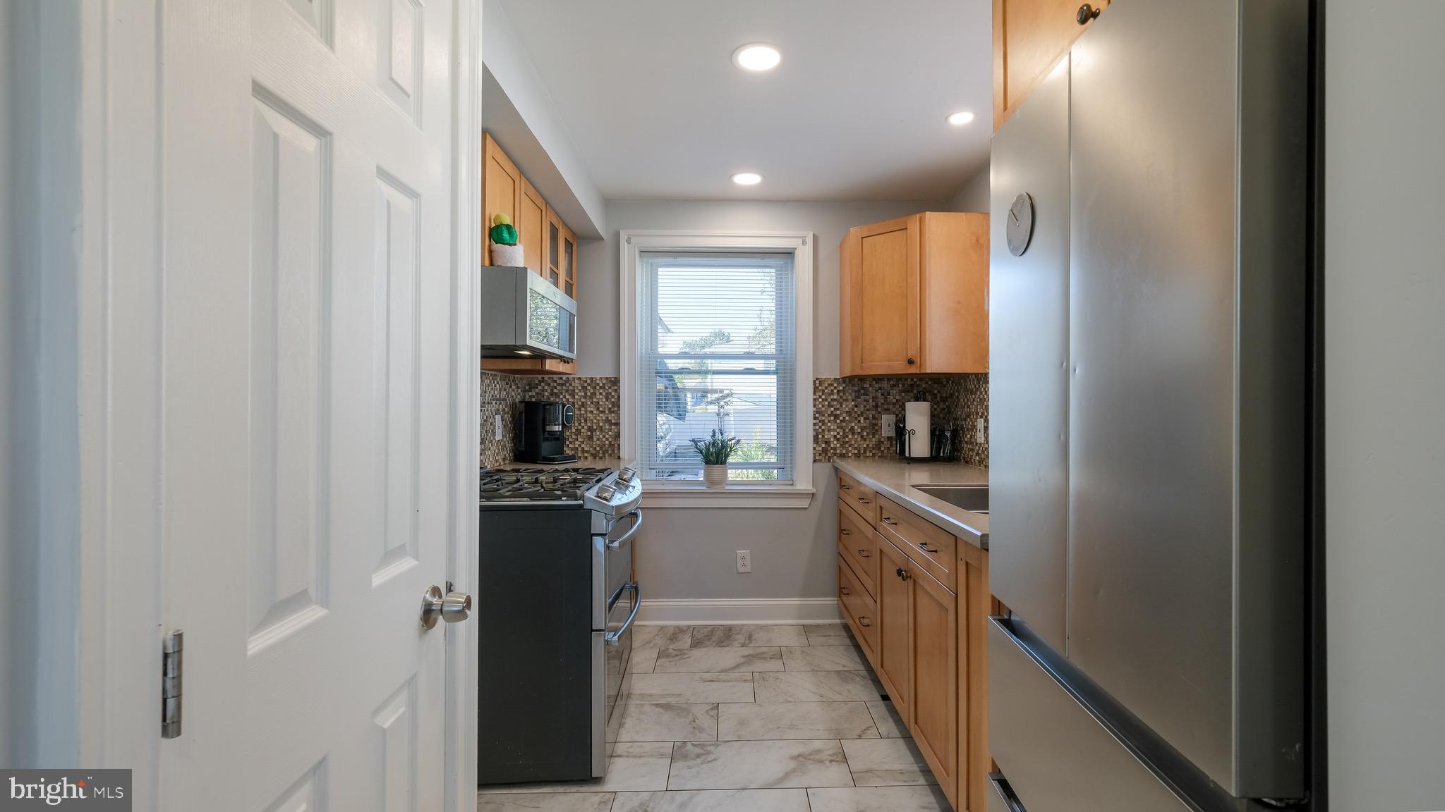 712 North York Road Willow Grove, PA 19090 - Photo 11 of 27 a kitchen with a refrigerator and a stove