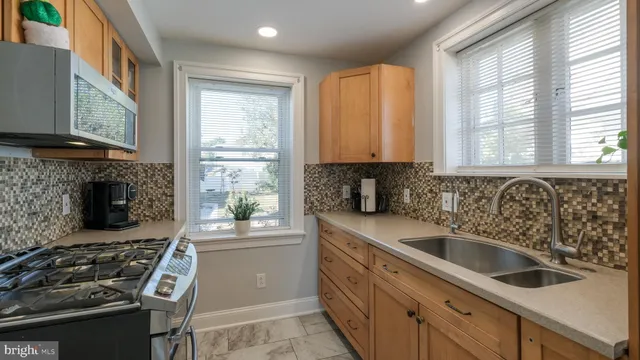 a kitchen that has a sink and a stove
