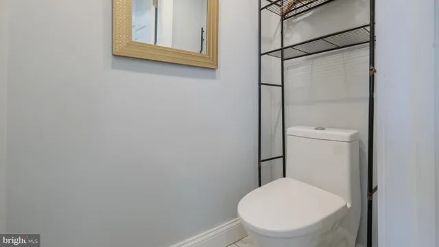 a white toilet sitting next to a bathroom sink