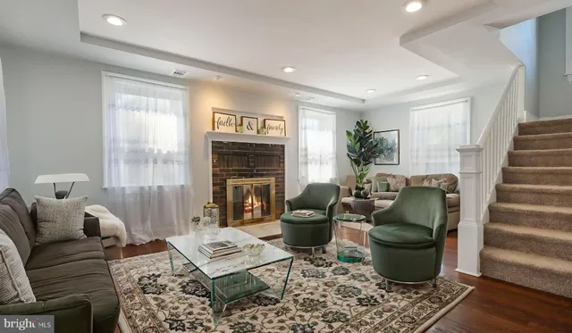 a living room with furniture and a fireplace