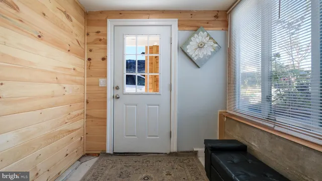 a view of a hallway with entryway door