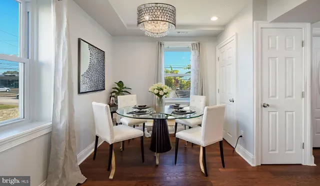 a view of a dining room with furniture window and wooden floor