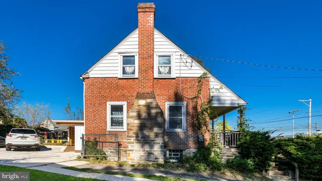 a view of house with a yard and sitting area