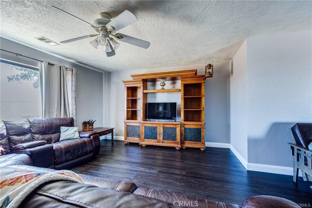 10971 Adobe Road Oak Hills, CA 92344 - Photo 11 of 49 a living room with furniture and wooden floor