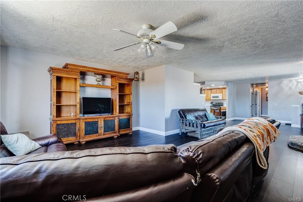 10971 Adobe Road Oak Hills, CA 92344 - Photo 12 of 49 a living room with furniture and a flat screen tv