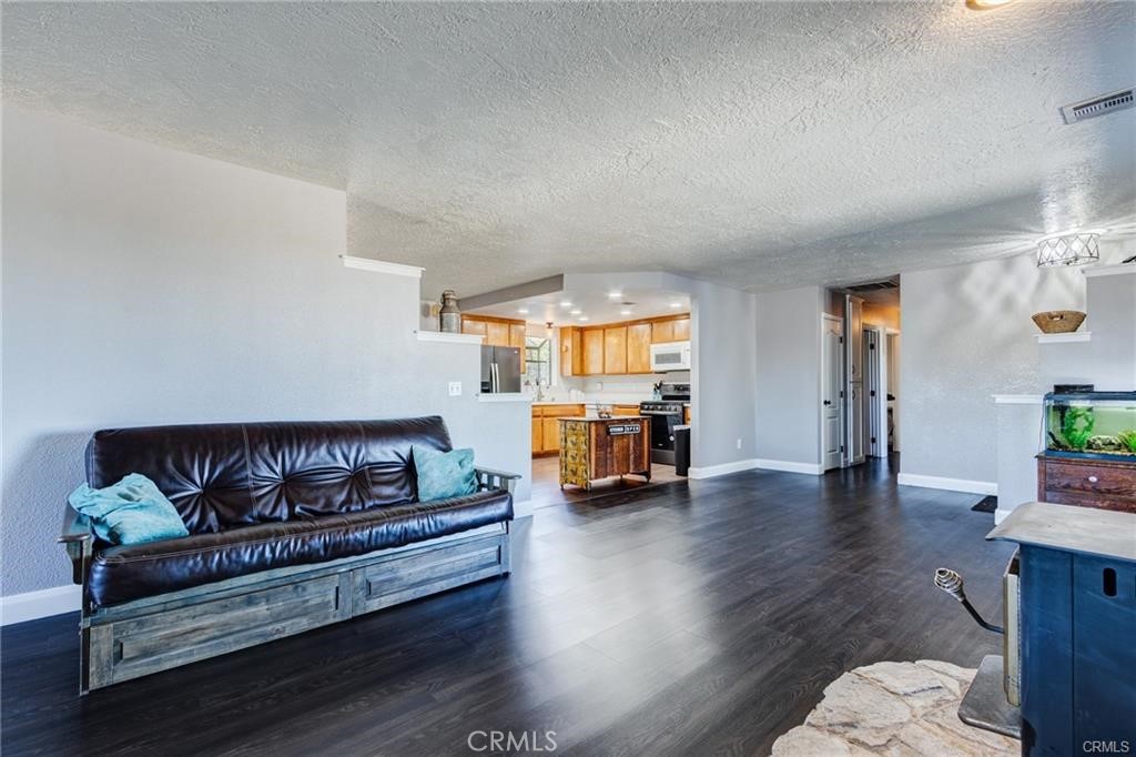 10971 Adobe Road Oak Hills, CA 92344 - Photo 13 of 49 a living room with furniture and wooden floor