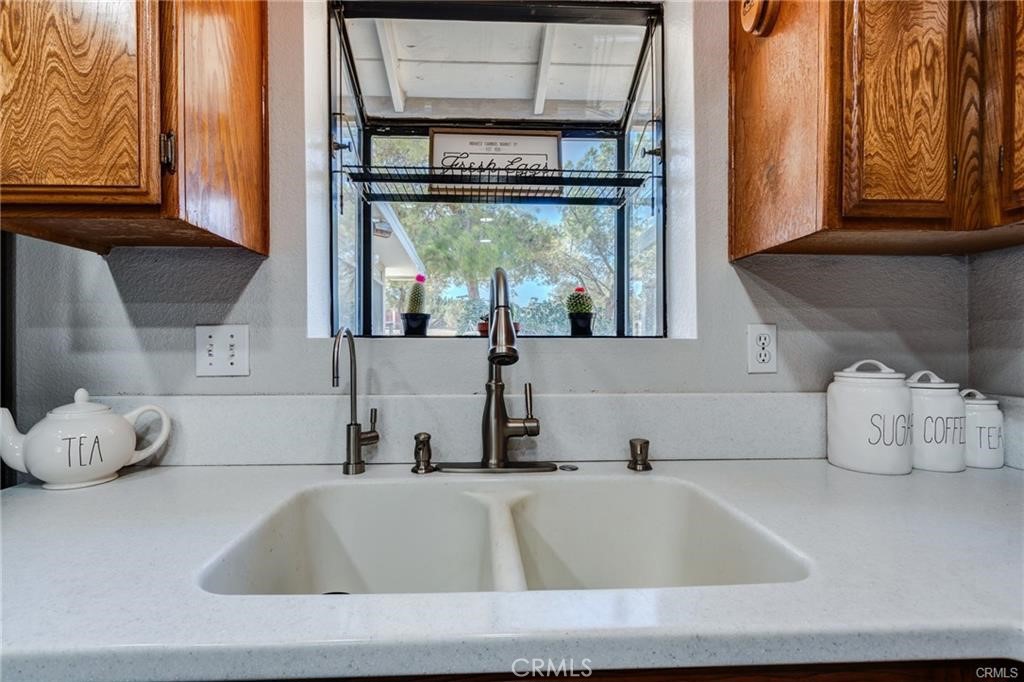 10971 Adobe Road Oak Hills, CA 92344 - Photo 16 of 49 a bathroom with washing machine and window