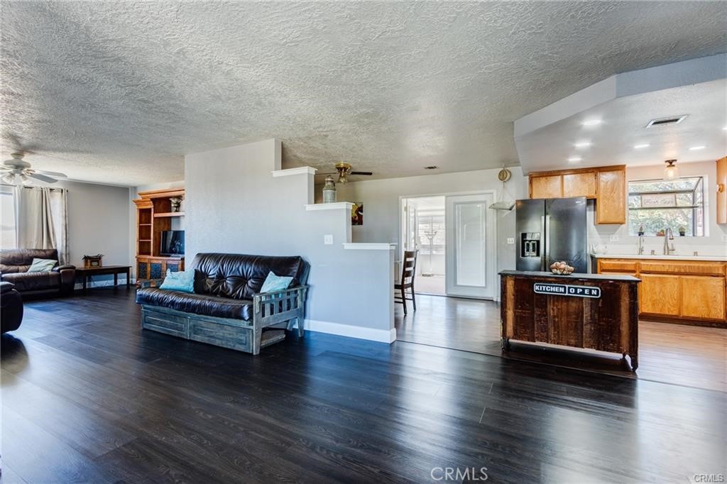10971 Adobe Road Oak Hills, CA 92344 - Photo 22 of 49 a living room with furniture and a wooden floor