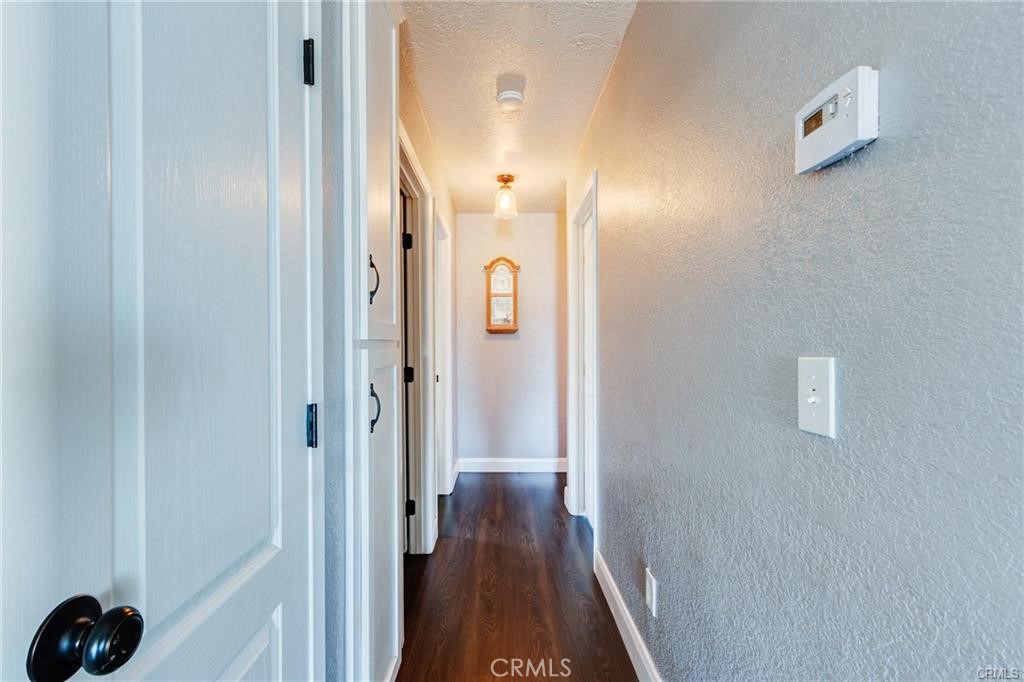 10971 Adobe Road Oak Hills, CA 92344 - Photo 23 of 49 a view of a hallway with wooden floor