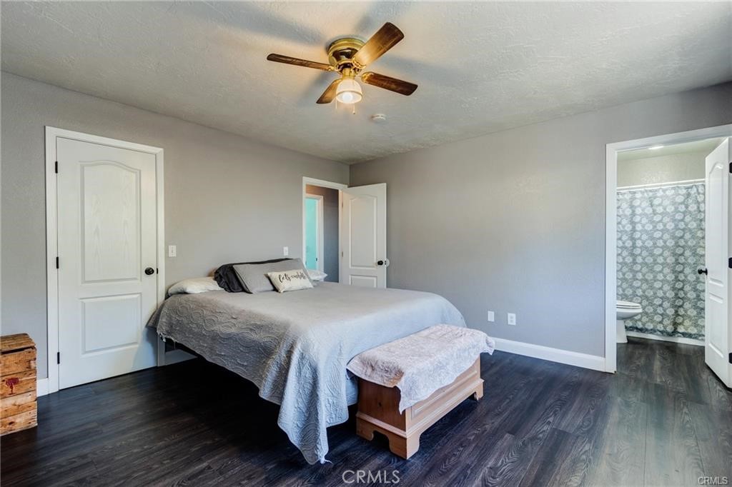 10971 Adobe Road Oak Hills, CA 92344 - Photo 25 of 49 a bedroom with a bed a dresser and wooden floor