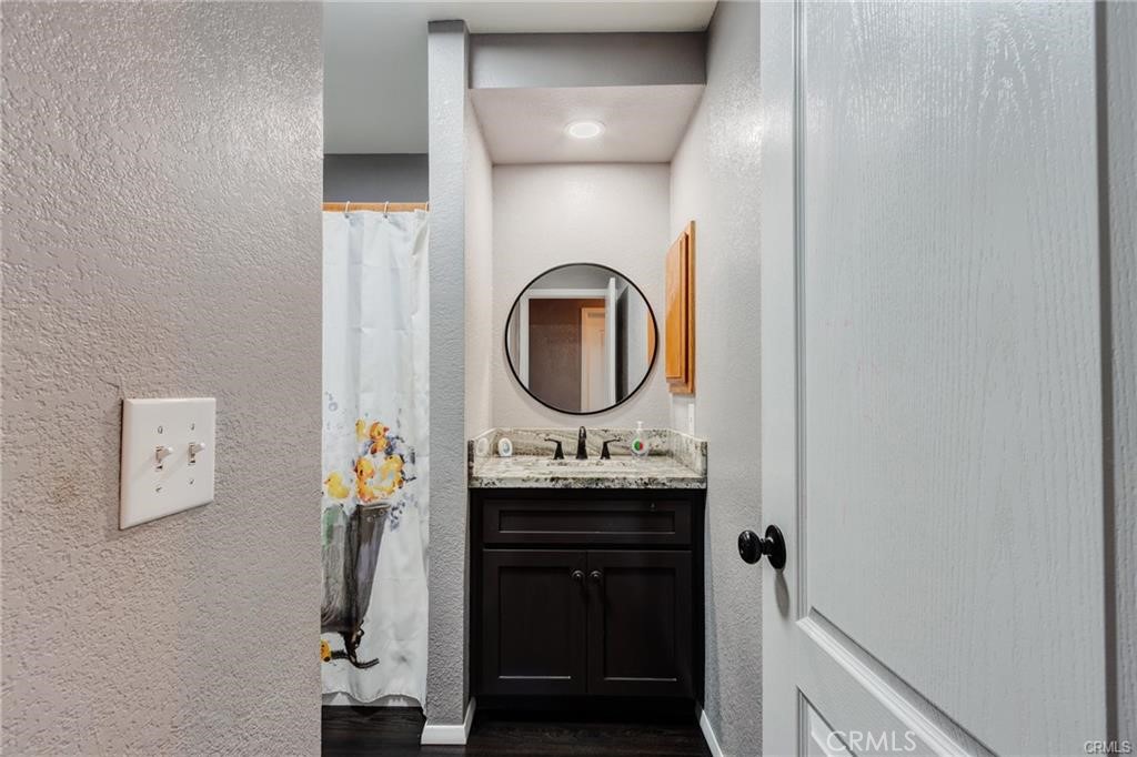 10971 Adobe Road Oak Hills, CA 92344 - Photo 27 of 49 a bathroom with a sink and a mirror