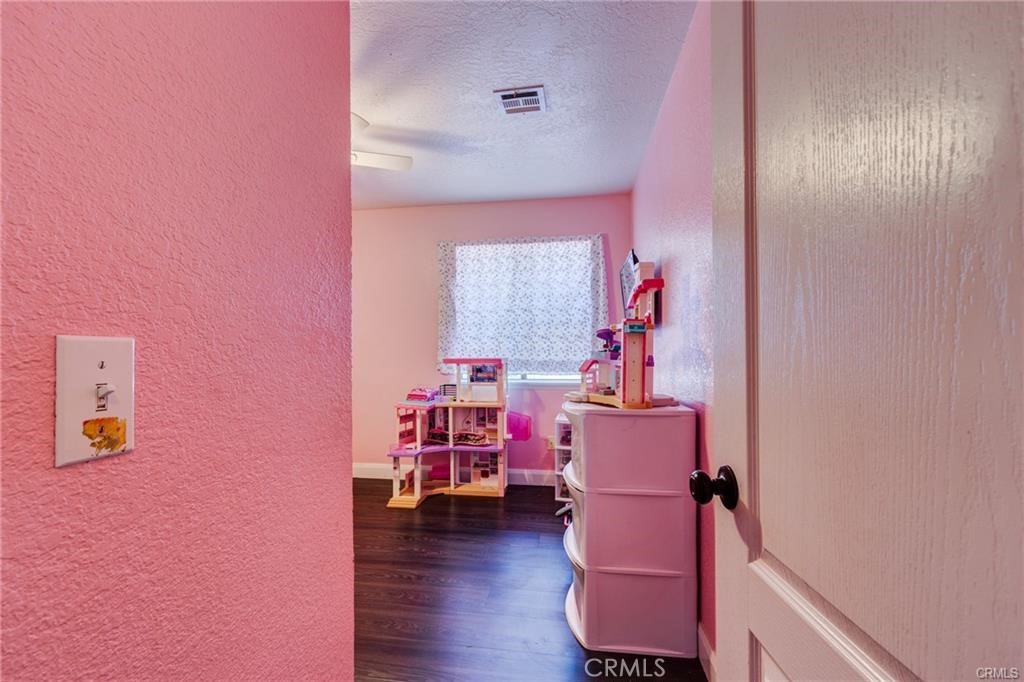 10971 Adobe Road Oak Hills, CA 92344 - Photo 31 of 49 a room with furniture and wooden floor