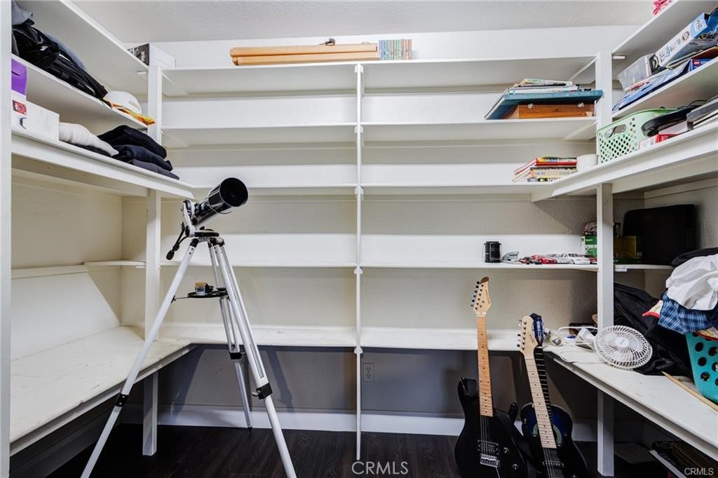 10971 Adobe Road Oak Hills, CA 92344 - Photo 33 of 49 a view of walk in closet with clothes and shoes