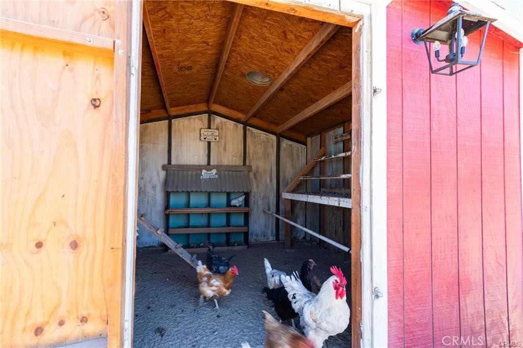 10971 Adobe Road Oak Hills, CA 92344 - Photo 41 of 49 a view of a hallway with wooden shelves and entryway