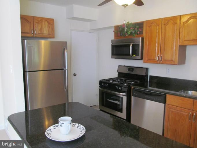 905 Southridge Road Catonsville, MD 21228 - Photo 13 of 14 a kitchen with stainless steel appliances granite countertop a refrigerator stove top oven a sink and dishwasher