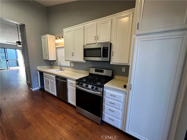 a kitchen with a stove microwave and sink