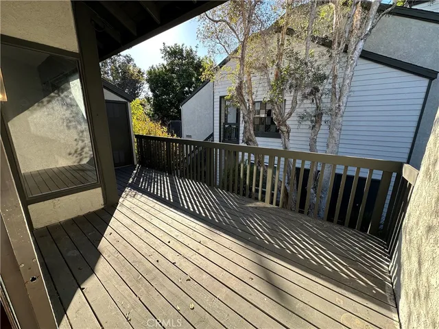 a view of balcony with wooden floor