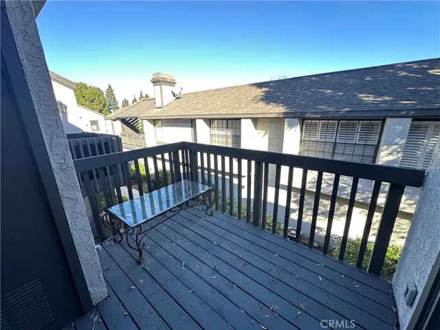 a view of a wooden chairs on the roof deck