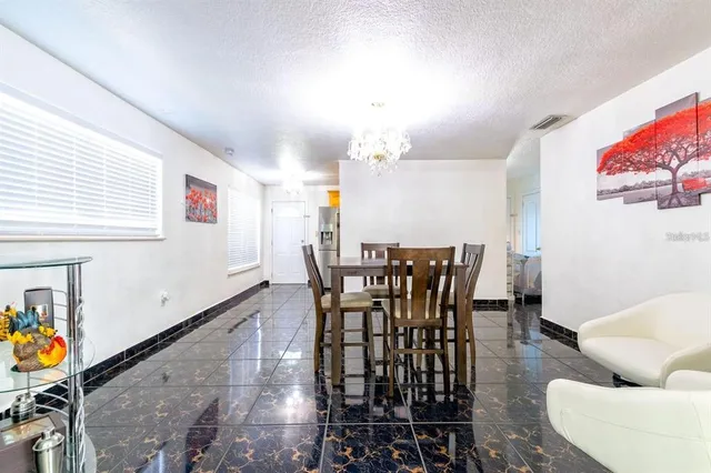 a view of a dining room with furniture and a potted plant