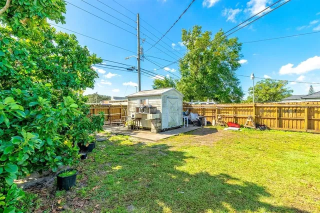 a backyard of a house with table and chairs
