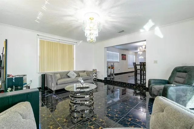 a living room with furniture and a chandelier