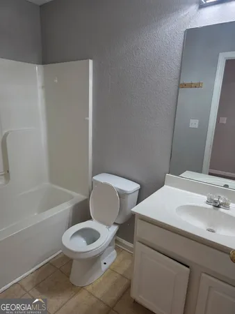 a bathroom with a toilet a sink and bathtub