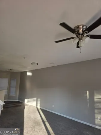 a kitchen with a refrigerator stove and white cabinets