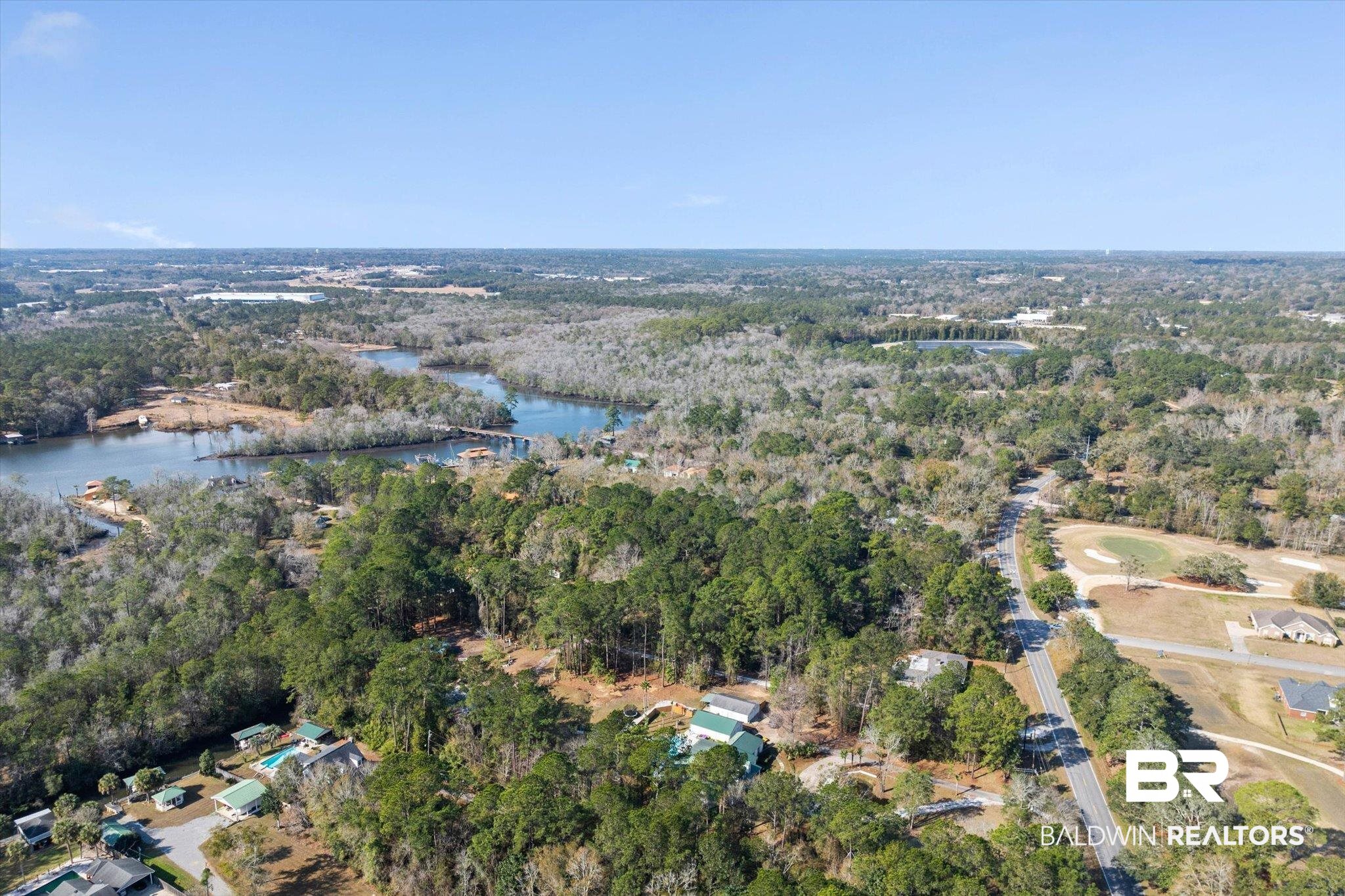 3847 Riviere Du Chien Road Mobile, AL 36693 - Photo 39 of 51 Aerial overview of property's location with a nearby body of water and a heavily wooded area