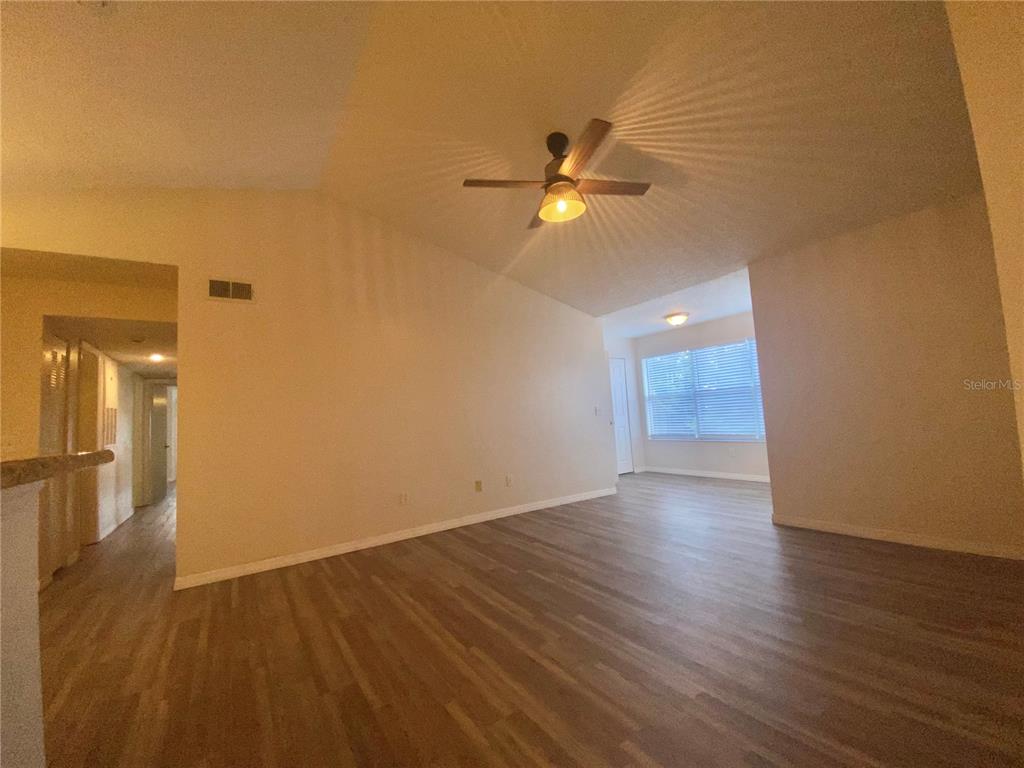 5144 Conroy Road, Unit 38 Orlando, FL 32811 - Photo 11 of 49 a view of empty room with wooden floor and ceiling fan