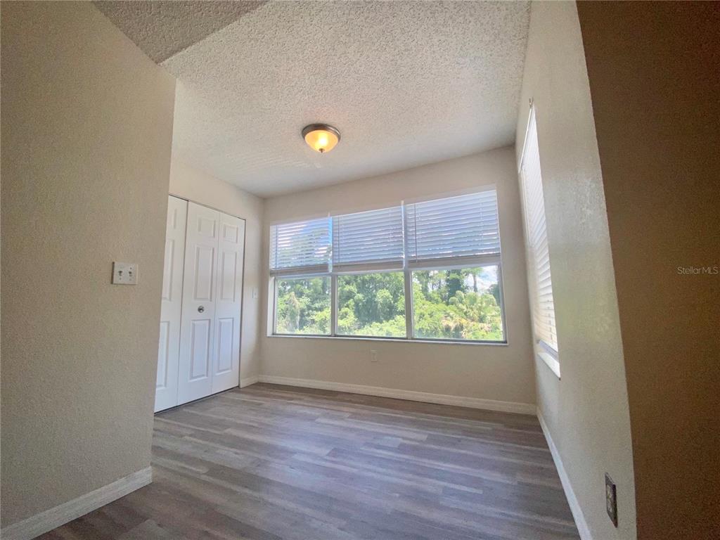 5144 Conroy Road, Unit 38 Orlando, FL 32811 - Photo 12 of 49 a view of an empty room with wooden floor and a window