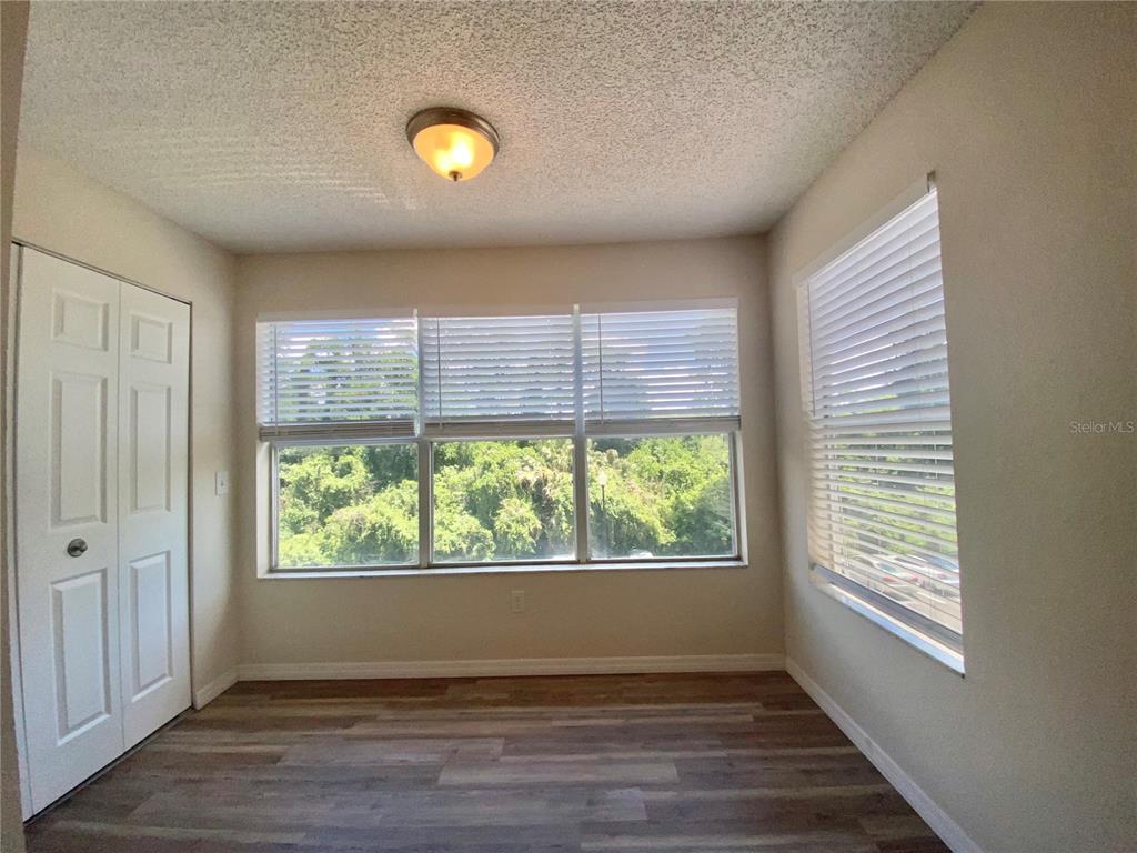 5144 Conroy Road, Unit 38 Orlando, FL 32811 - Photo 13 of 49 a view of an empty room with wooden floor and a window