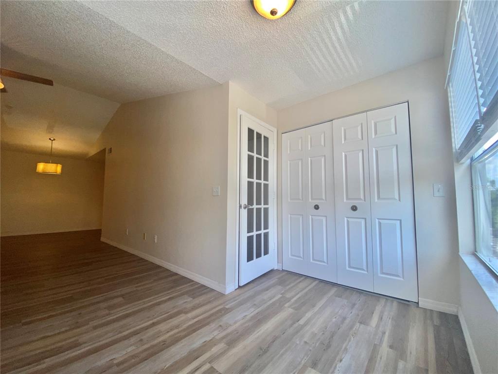 5144 Conroy Road, Unit 38 Orlando, FL 32811 - Photo 14 of 49 an empty room with wooden floor and windows