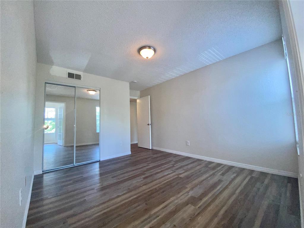 5144 Conroy Road, Unit 38 Orlando, FL 32811 - Photo 16 of 49 wooden floor in an empty room with a window