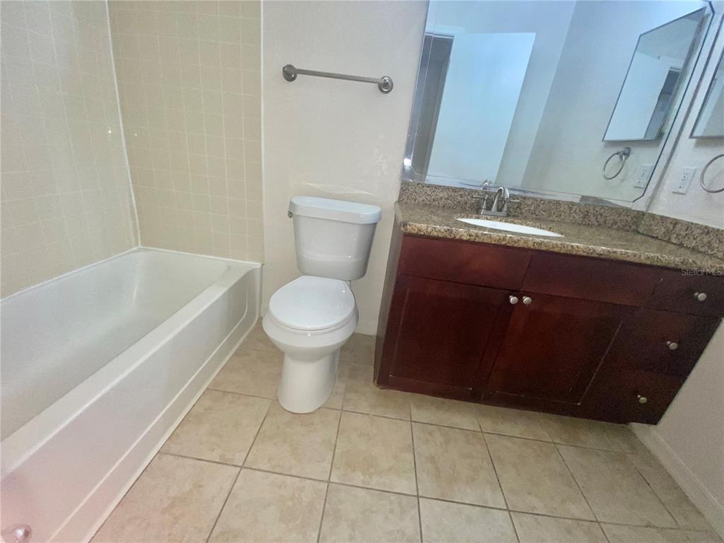 5144 Conroy Road, Unit 38 Orlando, FL 32811 - Photo 19 of 49 a bathroom with a sink a toilet and a bathtub