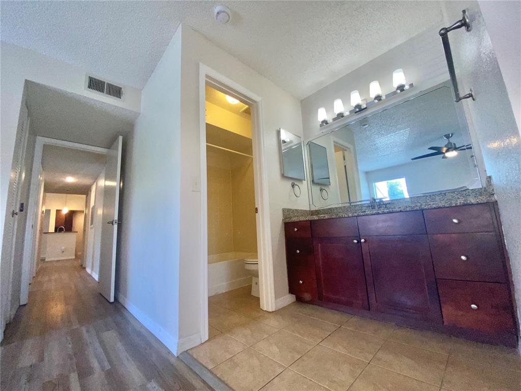 5144 Conroy Road, Unit 38 Orlando, FL 32811 - Photo 23 of 49 a bathroom with a sink and a mirror
