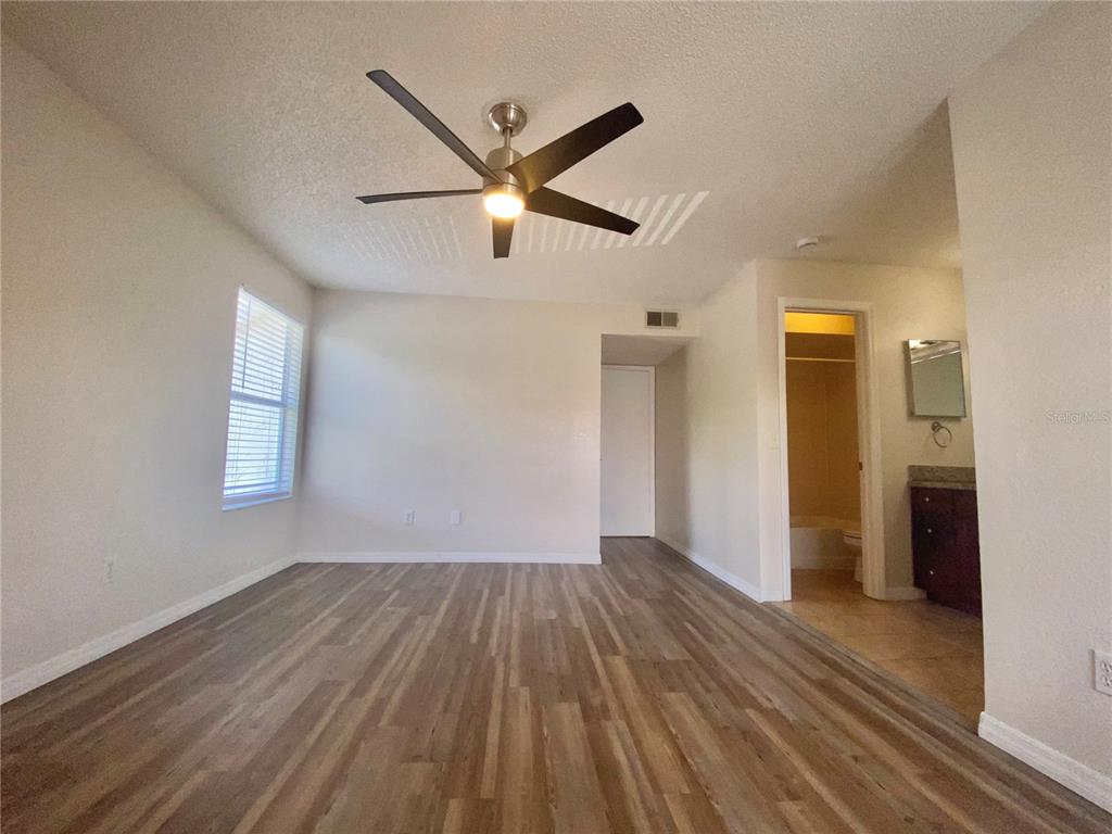 5144 Conroy Road, Unit 38 Orlando, FL 32811 - Photo 26 of 49 a view of empty room with wooden floor and fan