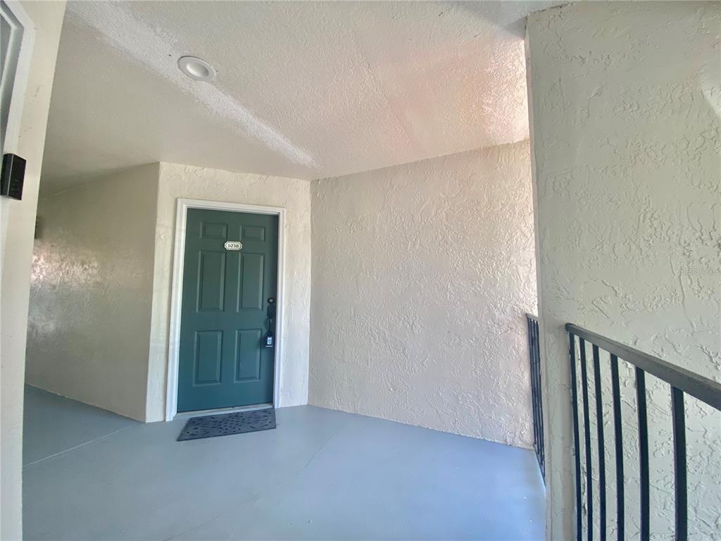5144 Conroy Road, Unit 38 Orlando, FL 32811 - Photo 3 of 49 an empty room with floor to ceiling window and carpet