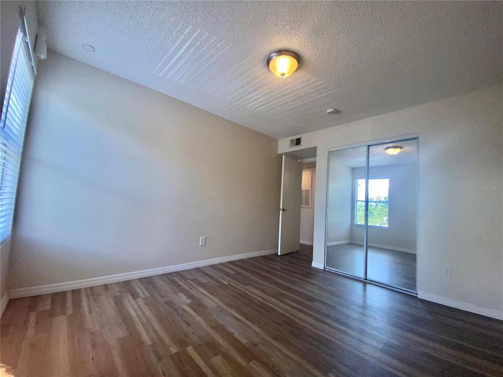 5144 Conroy Road, Unit 38 Orlando, FL 32811 - Photo 49 of 49 an empty room with wooden floor and windows