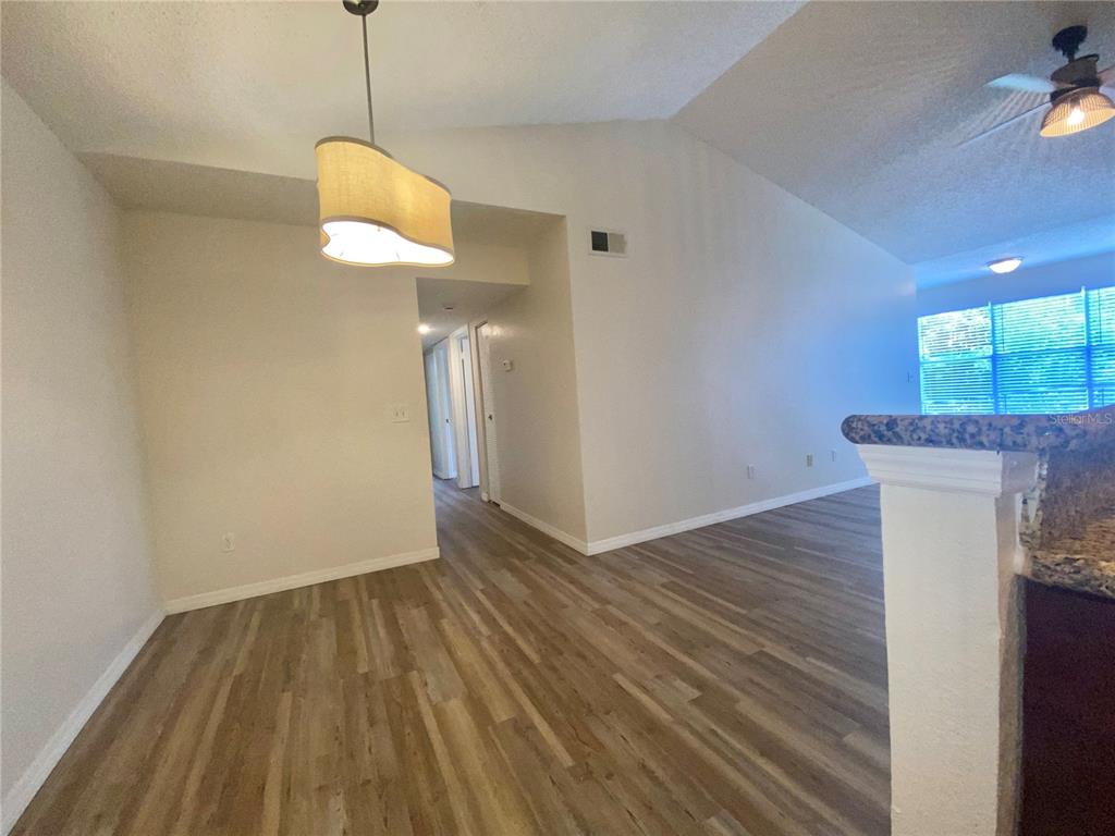 5144 Conroy Road, Unit 38 Orlando, FL 32811 - Photo 7 of 49 a view of a room with wooden floor and a ceiling fan