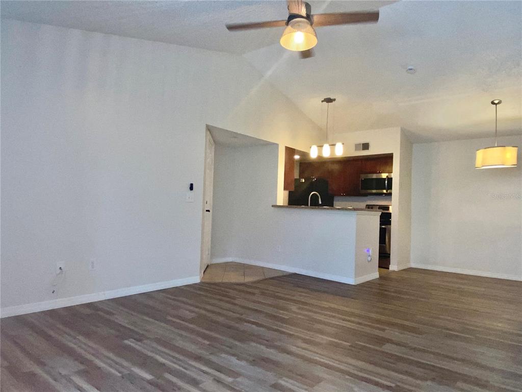 5144 Conroy Road, Unit 38 Orlando, FL 32811 - Photo 8 of 49 a view of a kitchen with a dishwasher and wooden floor