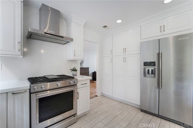 a kitchen with stainless steel appliances a stove a microwave and a refrigerator