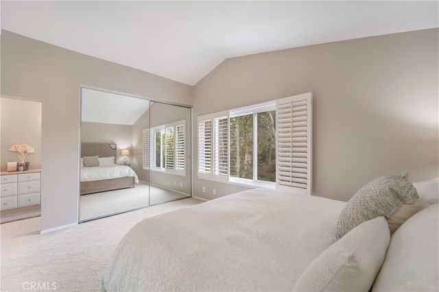 a bedroom with a large bed and a large window