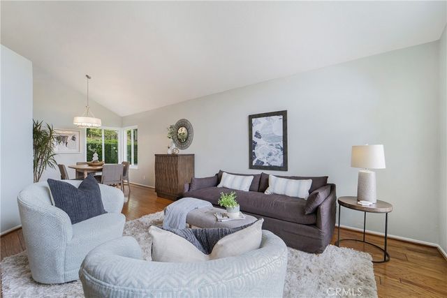a living room with furniture and a lamp