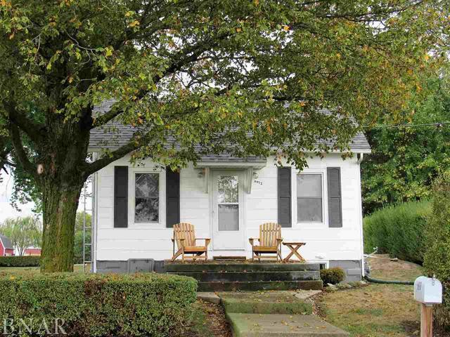 a front view of a house with sitting area